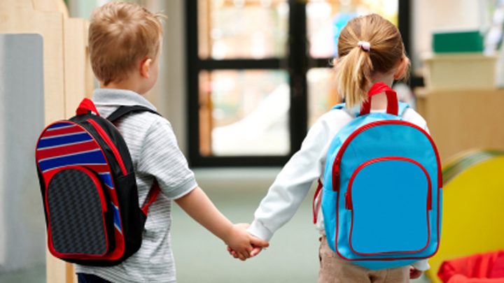 Two school children holding hands