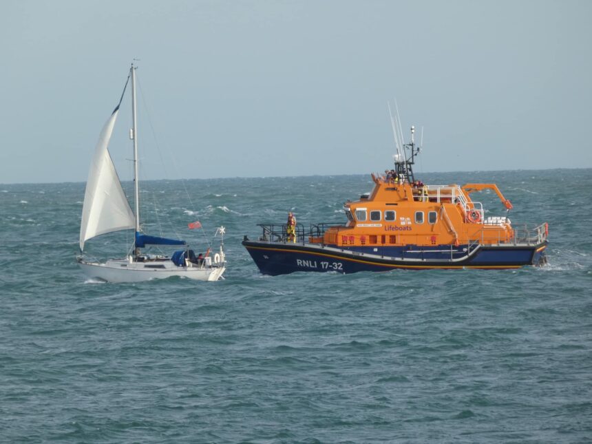 All weather lifeboat escorting yacht
