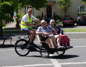 Keith the Cycle without Age volunteer is seen here giving a Trishaw ride to The Dorchester Mayor Councillor Janet Hewitt and Castle View Care Home resident David Gale