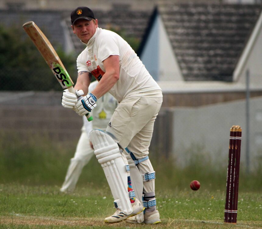 Batsman Matt Randall strikes a boundary for Portland Red Triangle against Beaminster