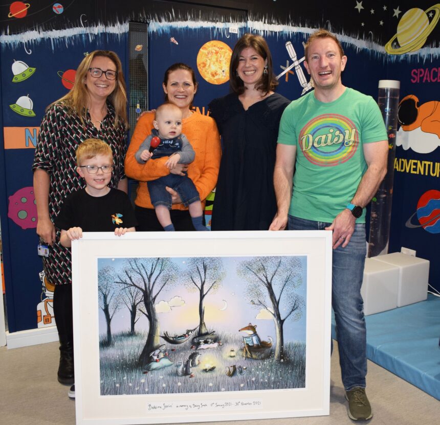 From the left: Clare Hollingsworth, Zac, Katie with baby Toby, artist Lorna and Graham with the picture Graham and Katie commissioned for Kingfisher Ward