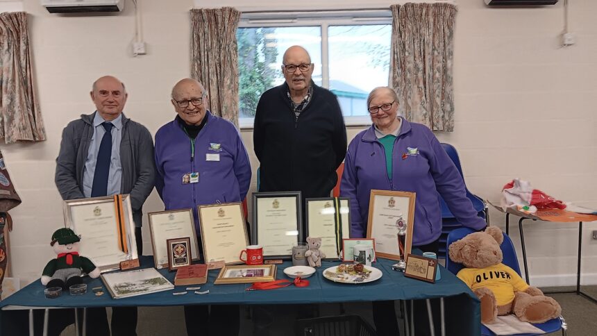 From left: Rob Mott, Peter Foster, Mike Streeter and Heather Foster with the display of Jim's awards