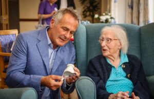 Antiques expert, Paul Martin, chats to Jean, 105, at Maiden Castle House care home