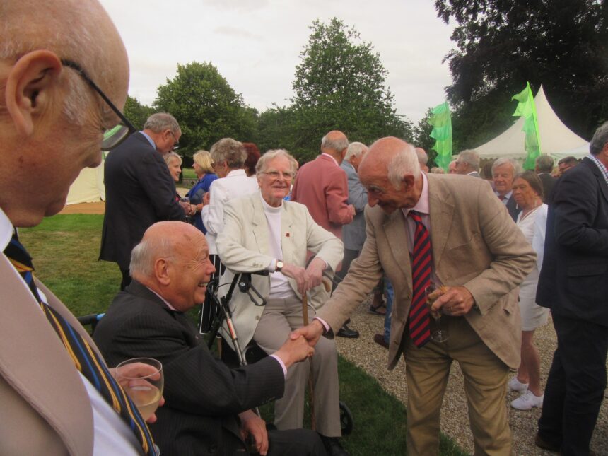 Lord Fellowes greets members, including Deputy President Paul Atterbury. Rev Dr John Travell, the Society’s Chaplain, looks on.