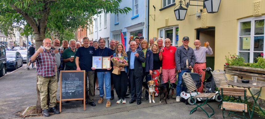 West Dorset CAMRA Chairman presents Darren Moore & Alison Legg of the Woodman their awards alongside CAMRA Regional Rep Norman Clinnick. Photo by Rich Gabe