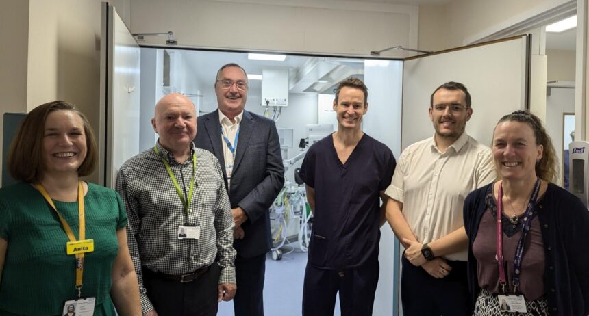 A photo of colleagues from Dorset HealthCare and DCH outside the new theatre at Weymouth Community Hospital.