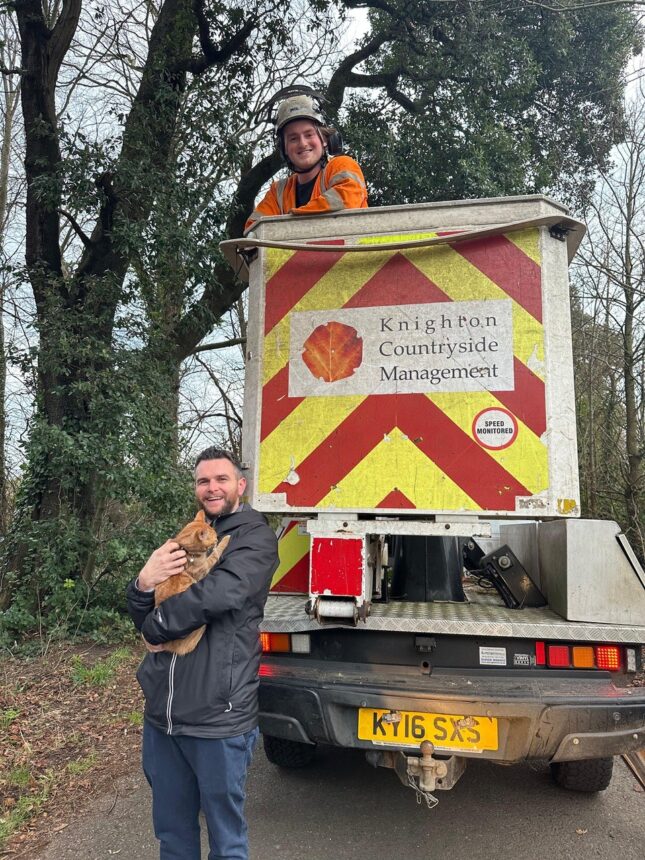 Photo: Elliott Sawyer holding Otto the Cat with tree surgeon George Emery from Knighton Countryside Management.