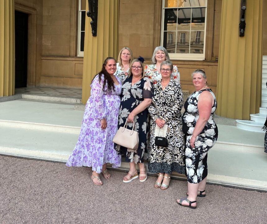 the team outside Buckingham Palace