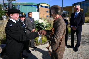 The Princess Royal is presented with a posy by Amber Loring-Arnot, Cadet of the Year award winner