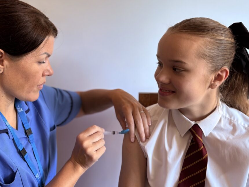 Dorset HealthCare's Immunisation nurse Charlene Corral vaccinating a child against flu