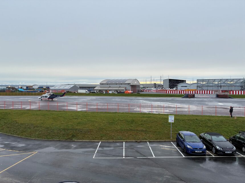 Portland Heliport with existing building to rear and new building to right of the landing strip