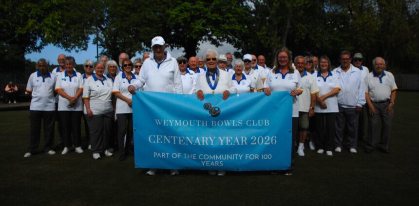 Pictured front left to right with banner. Club Secretary, Paul Ramsey. Club President, Sylvia Reynolds. Club Treasurer Yvonne Harland.